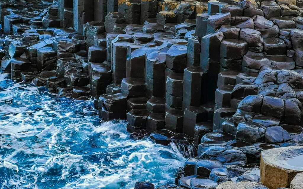 Hexagonal basalt columns of the Giant's Causeway with waves breaking