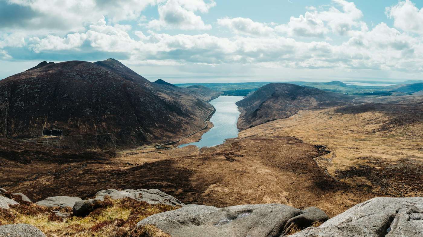 Granite peaks of the Mourne Mountains above a valley reservoir in County Down