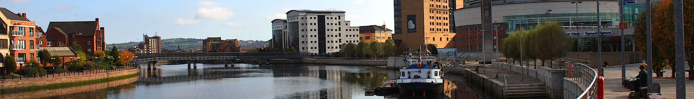 The River Lagan in Belfast with the Waterfront Hall and the Lagan Weir footbridge
